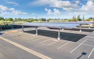 Coatinc US team discussing custom galvanizing solutions for a solar carport