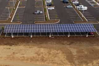Technician inspecting a galvanized solar panel frame