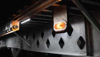 Close-up of a galvanized trailer component showing the zinc coating