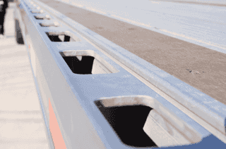 A galvanized utility trailer enduring outdoor conditions